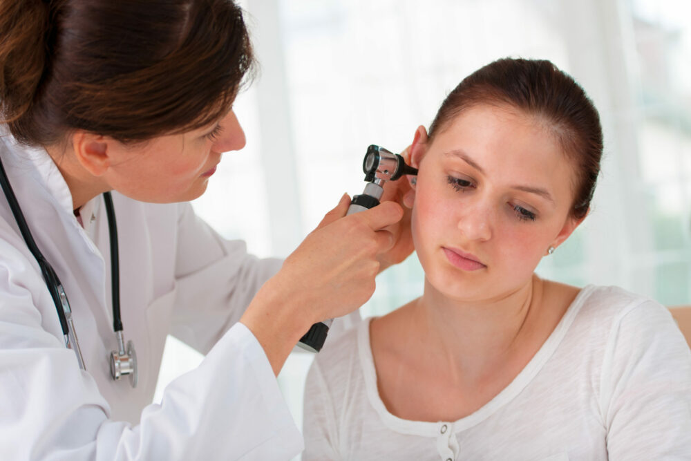 otolaryngology specialist looking in at patient's ear