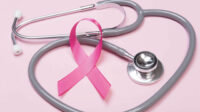 Pink ribbon breast cancer and stethoscope on pink