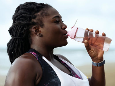 woman drinking water to prevent hangover